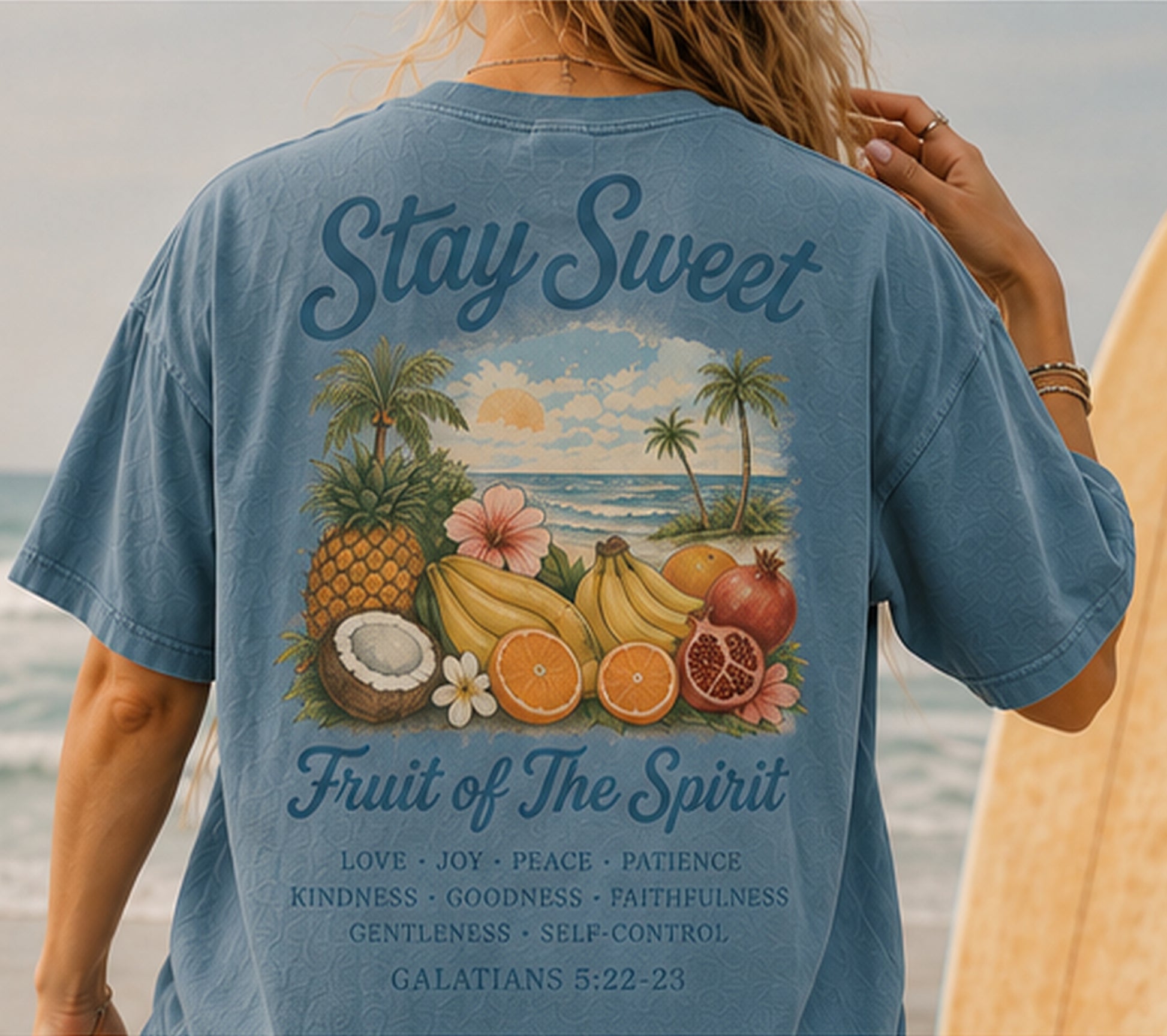 Person wearing a blue t-shirt with a tropical design and Fruit of the Spirit verse