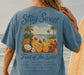 Person wearing a blue t-shirt with a tropical design and Fruit of the Spirit verse