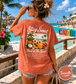 Woman wearing a 'Stay Sweet Fruit of the Spirit' t-shirt by a tropical beach with 'Cancun' sign.