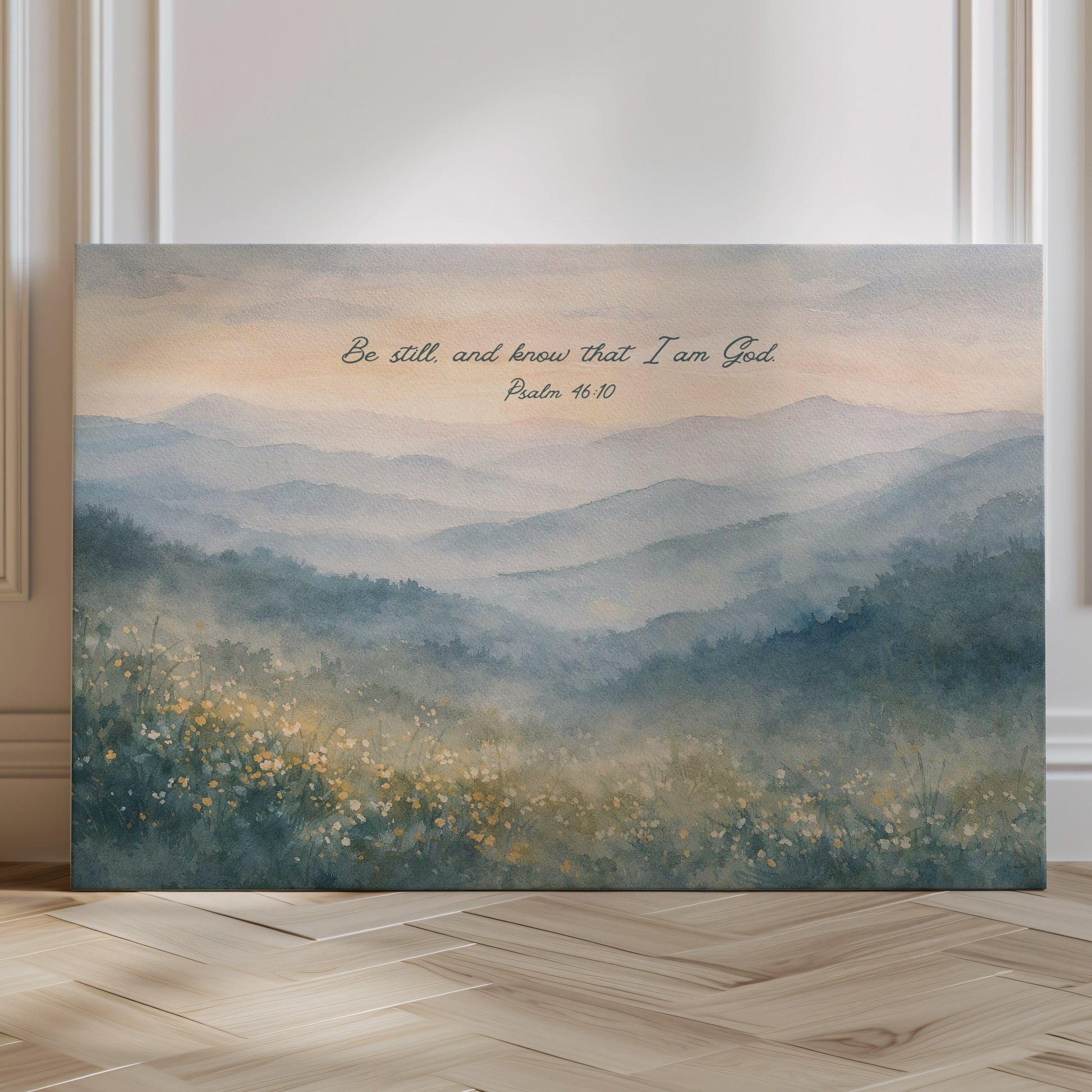 Decorative wall art with a mountain landscape and inspirational quote on a wooden floor.